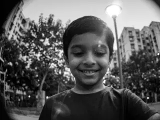 the dial camera, looking up at him: Aarav smiling down at his watch