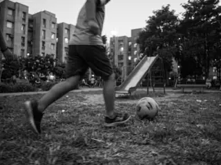 to the left: a friend running past with a football